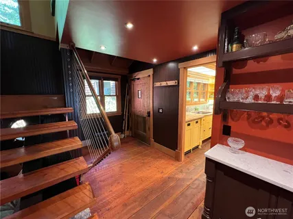 a hallway with a large mirror and a projector screen