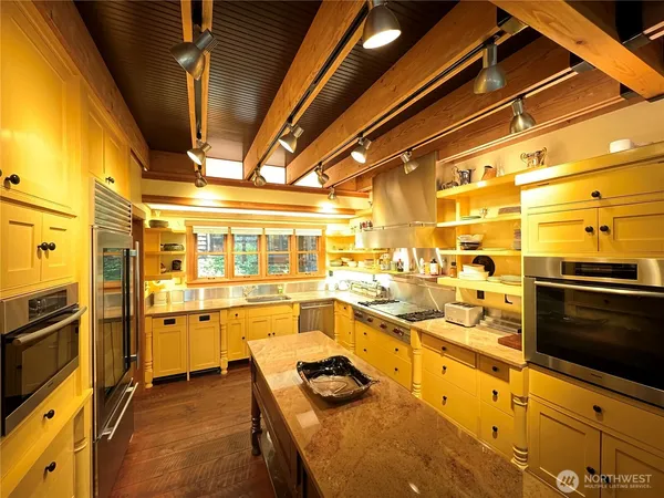 a kitchen with stainless steel appliances a stove a sink and a refrigerator