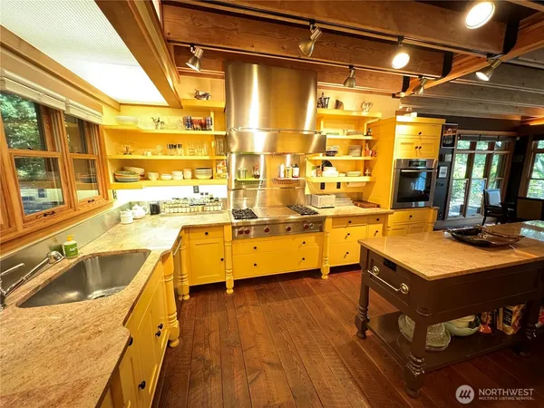 a kitchen with a sink appliances and a counter top space