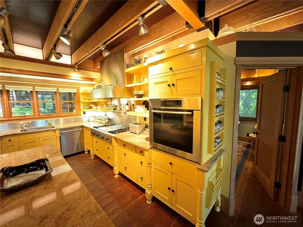 a kitchen with stainless steel appliances a stove and a refrigerator