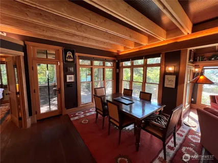 a view of a dining room with furniture wooden floor and a potted plant