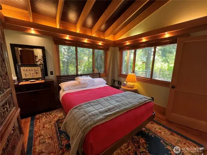 a bed sitting in a bedroom next to a window