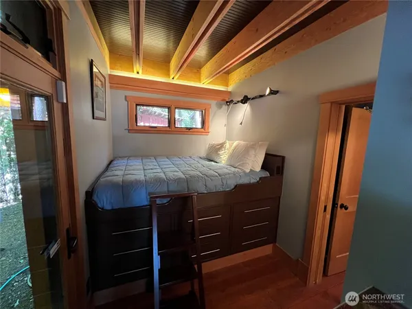 a room that has a bed and a dresser in it