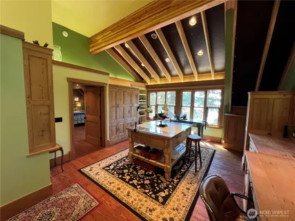 a living room with furniture rug and a table