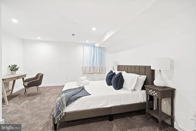 a bedroom with a bed and chair