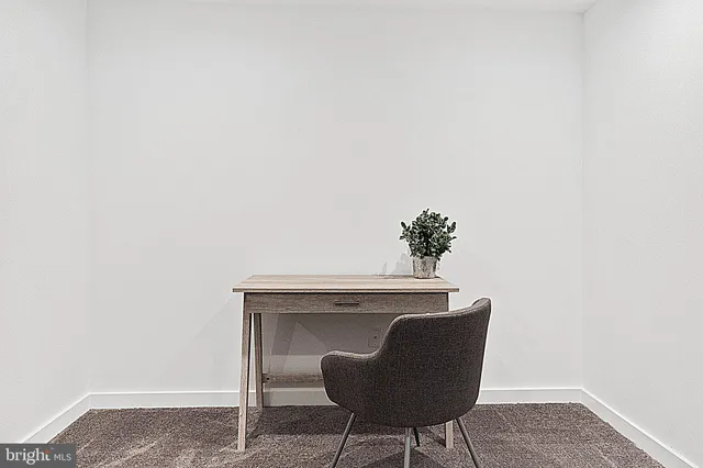 a dining room with furniture and a potted plant