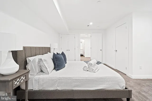 a bedroom with a bed and a couch