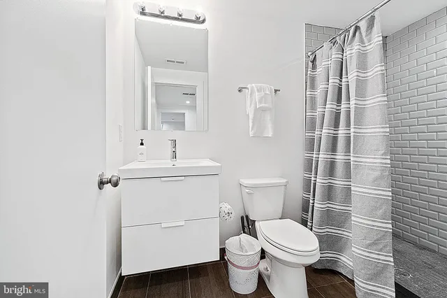 a bathroom with a toilet a sink and shower