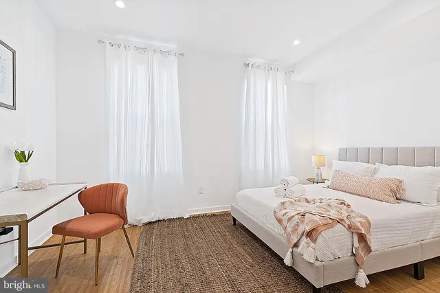 a bedroom with a bed and chair