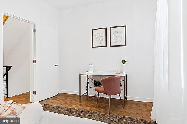a workspace room with furniture and wooden floor