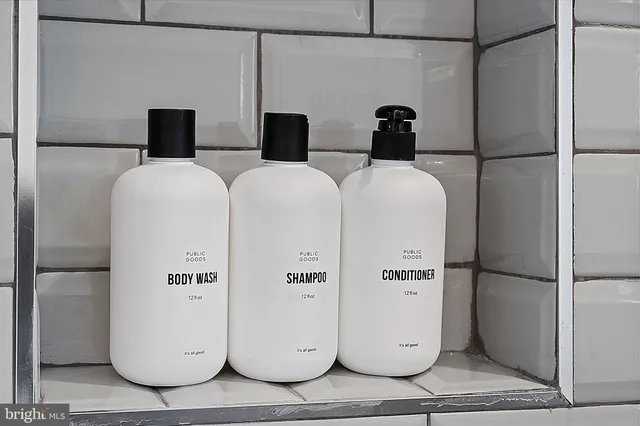 a bathroom with a refrigerator and mirror