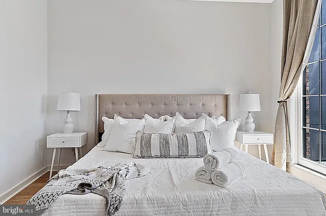 a large white bed in a white room