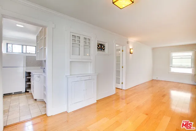 a view of a bedroom with wooden floor and cabinet