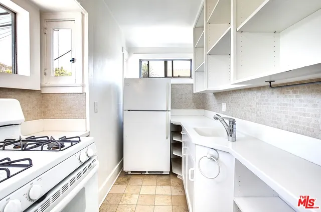 a kitchen with a sink a stove and refrigerator