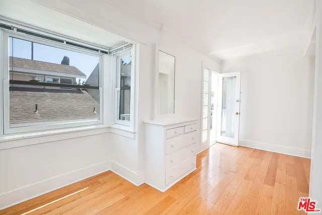 a view of a kitchen with wooden floor and cabinet