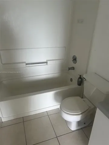 a view of an empty room and a window