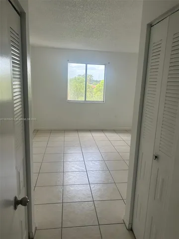 a kitchen with a refrigerator and a sink
