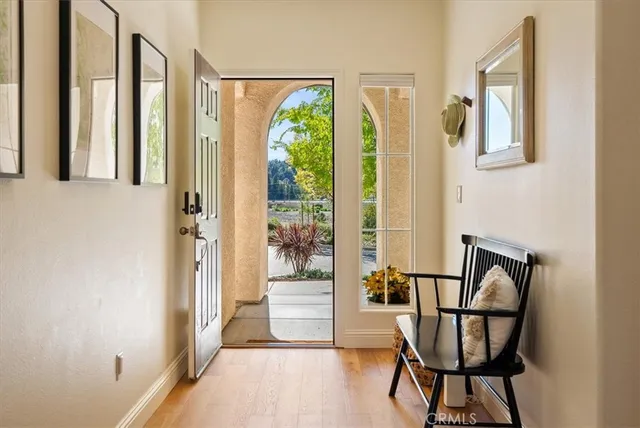 a view of a hallway with furniture and front door