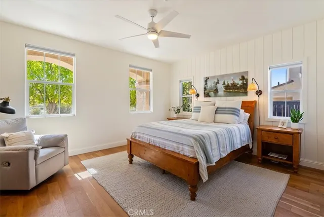 a bedroom with a bed couch and a window