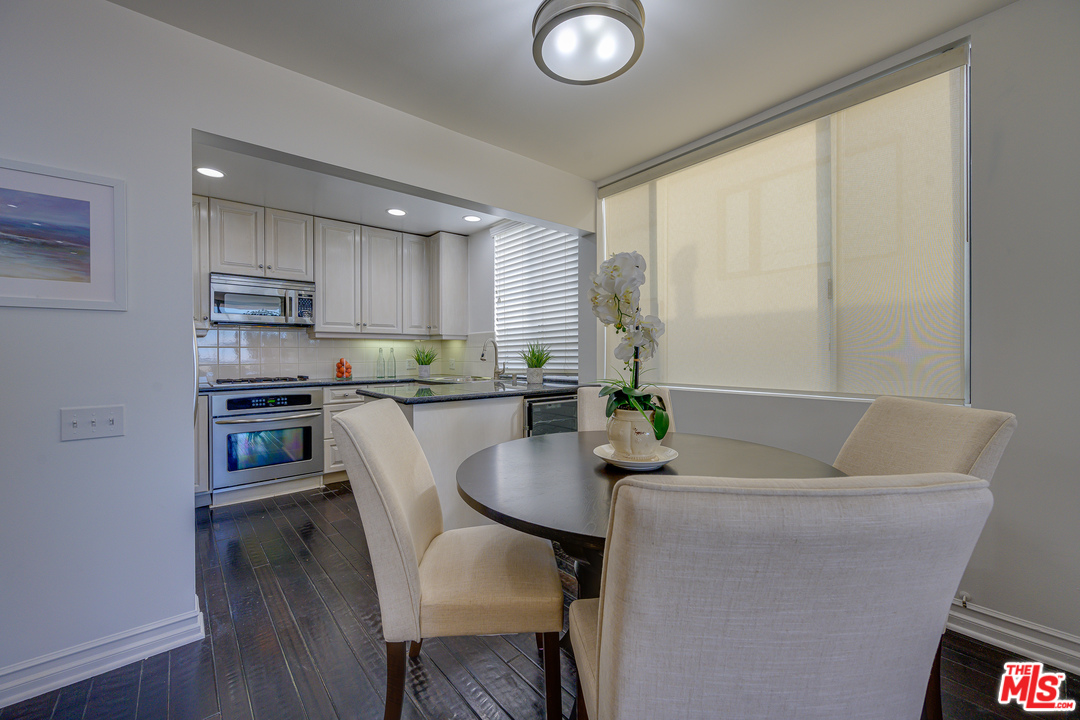 4 Quarterdeck Street, Unit 101 Marina del Rey, CA 90292 - Photo 23 of 29 a living room with kitchen island furniture and a wooden floor
