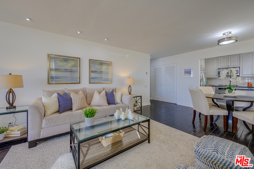 4 Quarterdeck Street, Unit 101 Marina del Rey, CA 90292 - Photo 27 of 29 a living room with furniture and a dining table with wooden floor