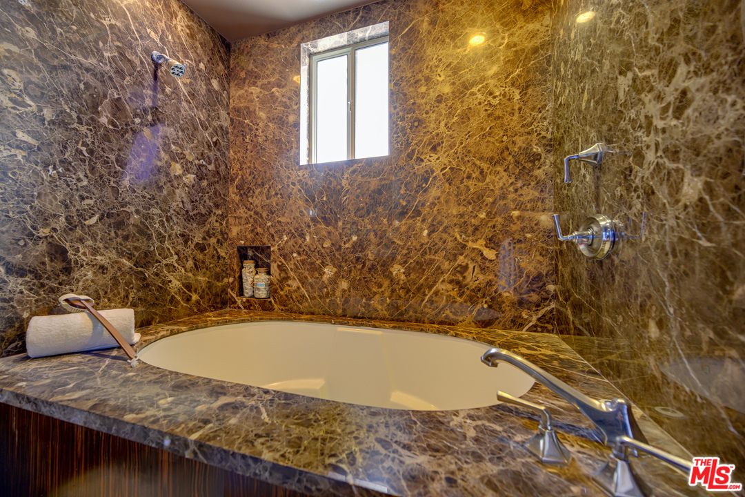 4 Quarterdeck Street, Unit 101 Marina del Rey, CA 90292 - Photo 5 of 29 a bathroom with a granite countertop sink and mirror