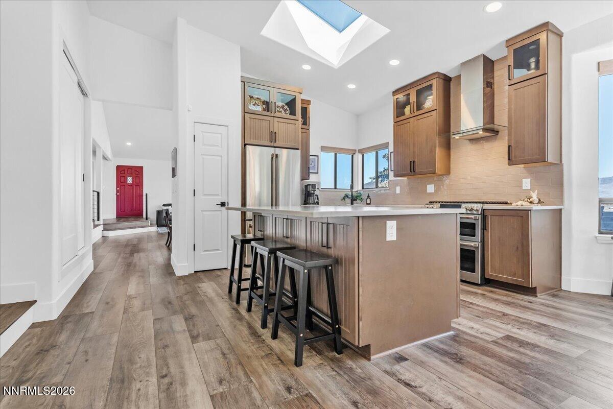 1243 Sharrow Way Carson City, NV 89703 - Photo 23 of 67 a kitchen with stainless steel appliances granite countertop a refrigerator a stove a sink dishwasher and white cabinets with wooden floor