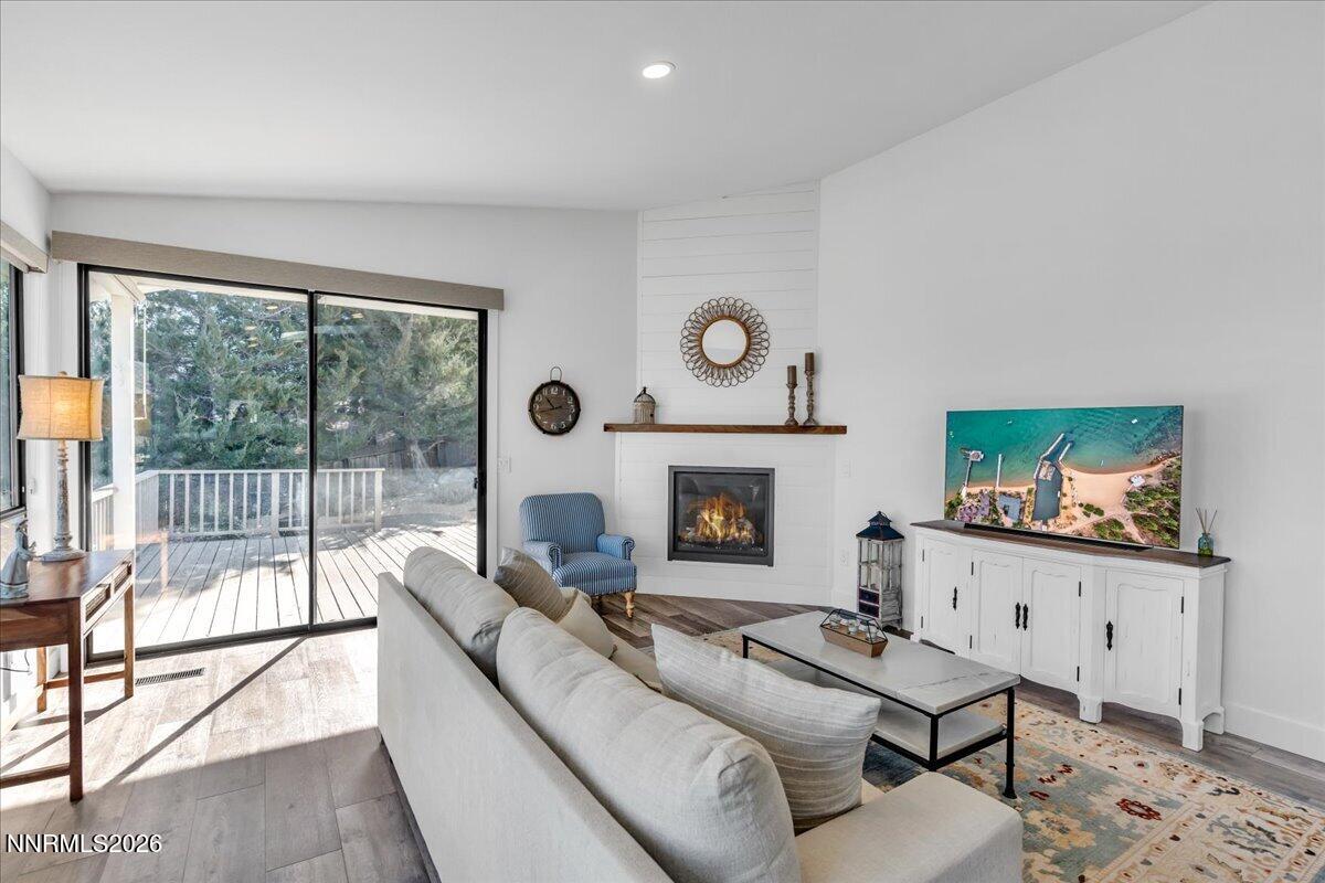 1243 Sharrow Way Carson City, NV 89703 - Photo 29 of 67 a living room with furniture a flat screen tv and a fireplace