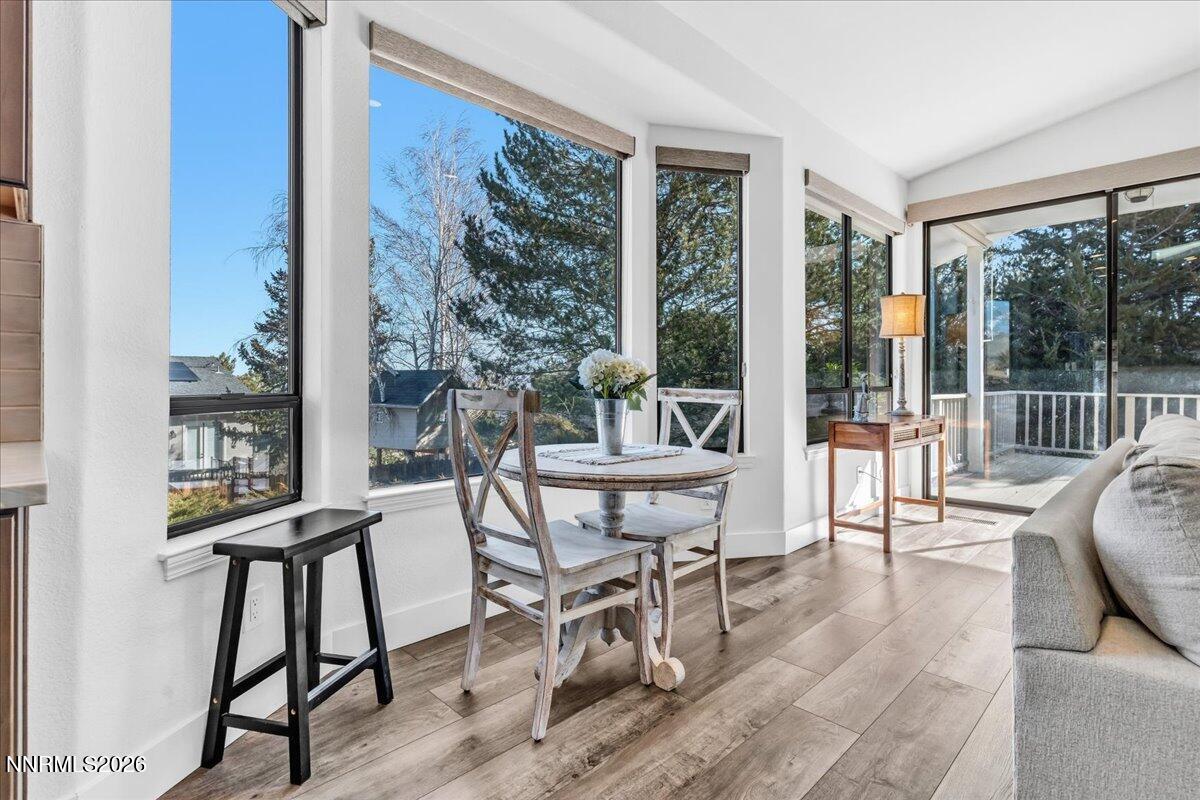 1243 Sharrow Way Carson City, NV 89703 - Photo 31 of 67 a view of a dining room with furniture large windows and wooden floor