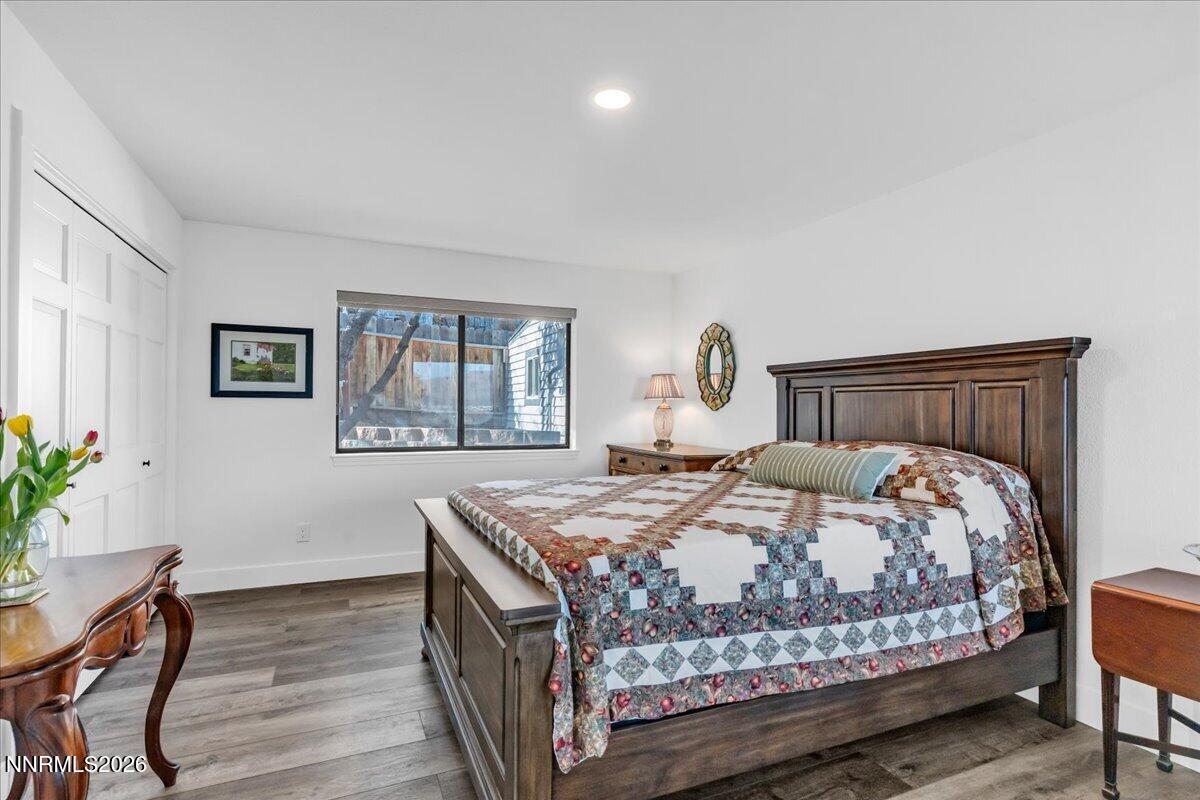 1243 Sharrow Way Carson City, NV 89703 - Photo 42 of 67 a bedroom with a bed and wooden floor