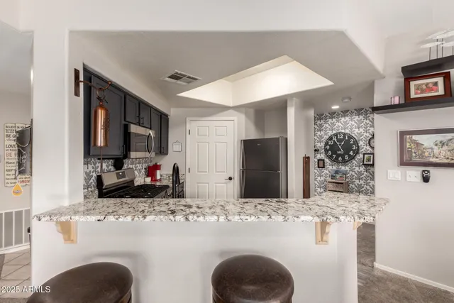 a bathroom with a granite countertop sink a large mirror and shower