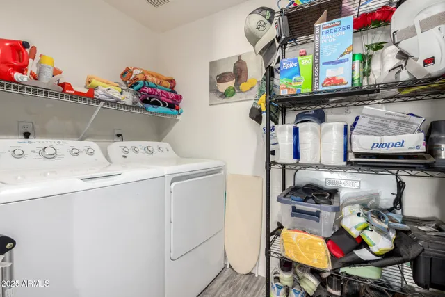a utility room with dryer washer and shoe rack