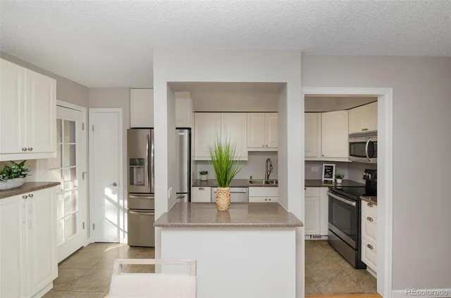 a kitchen with a sink and refrigerator