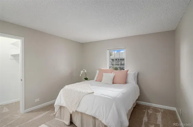 a bedroom with a bed and a mirror