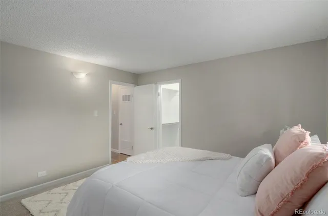 a bedroom with a bed and a lamp