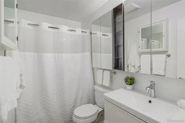 a white toilet sitting next to a bathroom sink