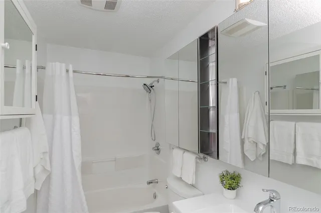 a bathroom with a shower and a bath tub