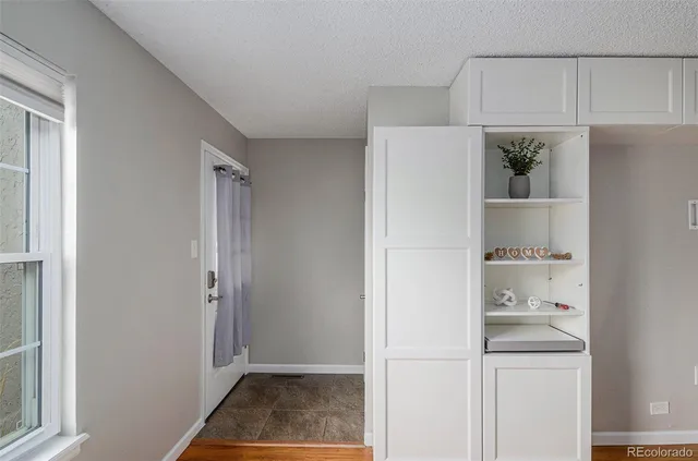 a view of kitchen with white cabinets