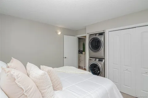 a bedroom with a washing machine and a sink