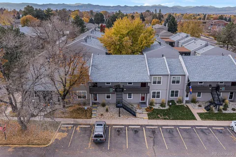 an aerial view of a house with a garden and lake view