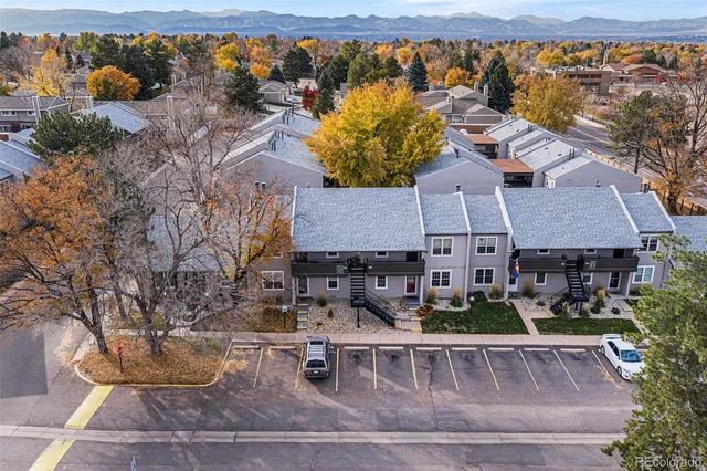 an aerial view of a house with garden space and street view