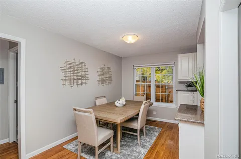 a workspace room with furniture and wooden floor