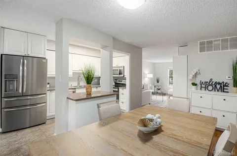 a kitchen with a refrigerator and a stove top oven