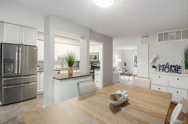 a kitchen with a refrigerator and a stove top oven