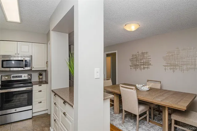 a view of a kitchen with dining table and chairs
