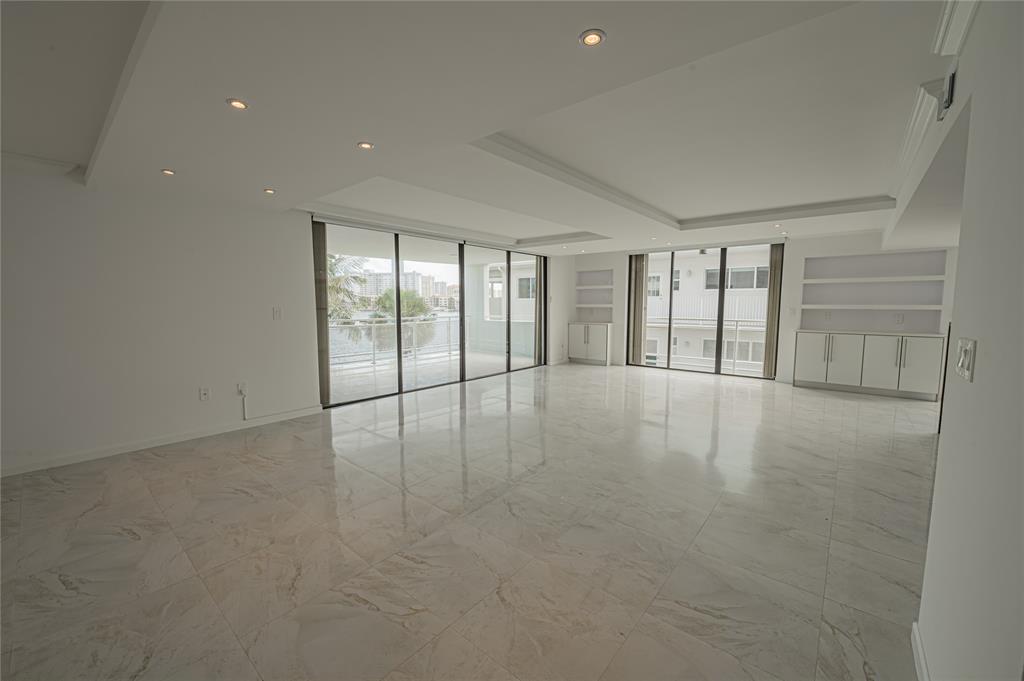 468 Golden Isles Drive, Unit 402 Hallandale Beach, FL 33009 - Photo 11 of 53 a view of an empty room with glass door