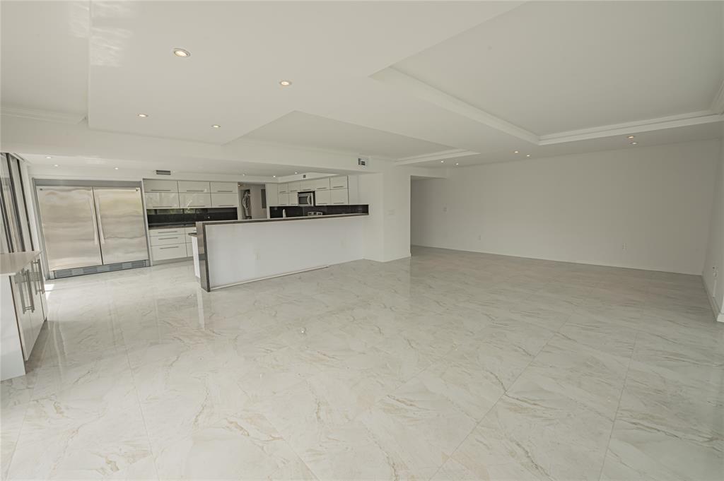 468 Golden Isles Drive, Unit 402 Hallandale Beach, FL 33009 - Photo 15 of 53 a view of a kitchen with cabinets and stainless steel appliances