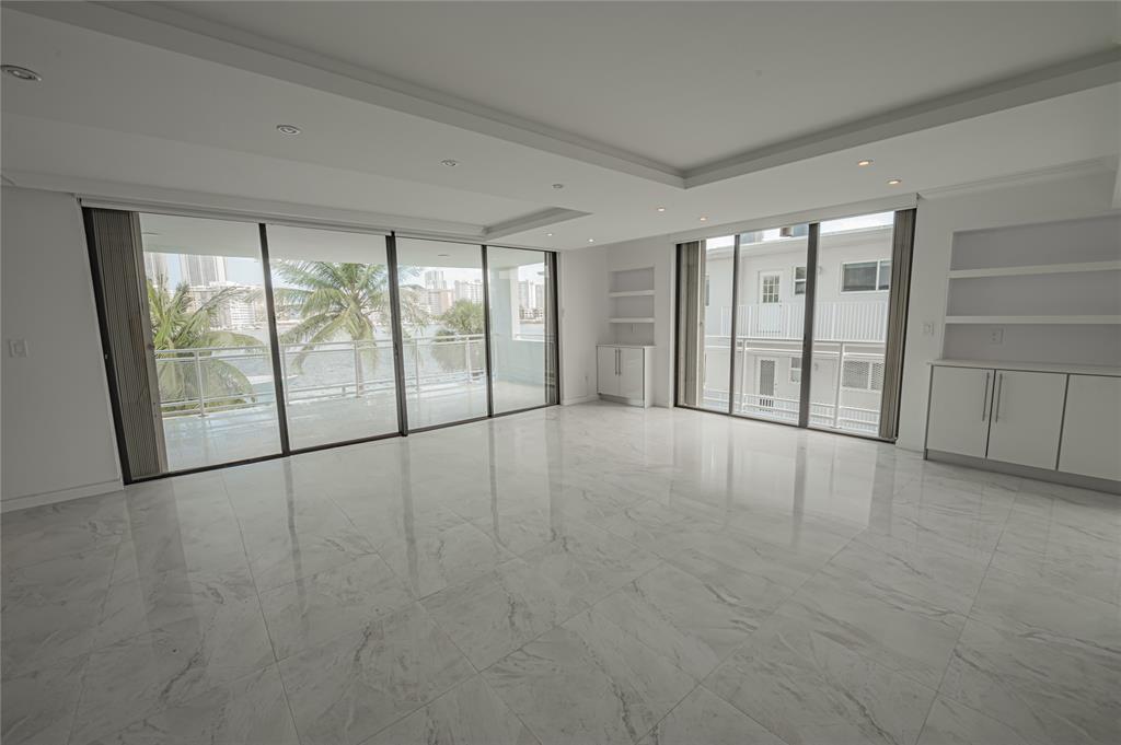 468 Golden Isles Drive, Unit 402 Hallandale Beach, FL 33009 - Photo 17 of 53 wooden floor in an empty room with a window