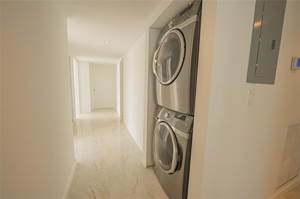 468 Golden Isles Drive, Unit 402 Hallandale Beach, FL 33009 - Photo 30 of 53 a utility room with dryer and washer