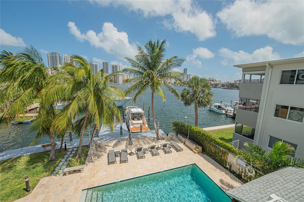 468 Golden Isles Drive, Unit 402 Hallandale Beach, FL 33009 - Photo 3 of 53 a view of a house with backyard and sitting area